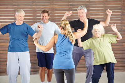 dancing class with happy senior people in a gym